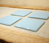 Powder blue opal fused art glass coaster 100x100mm size angled view